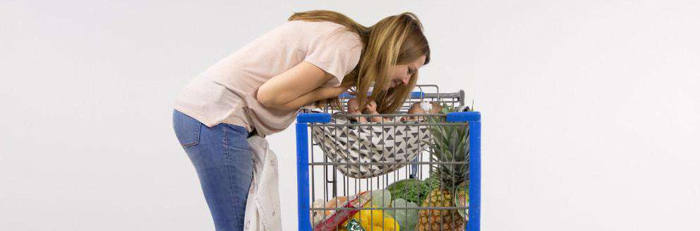 Lisa Pinnell, founder of Binxy Baby, shopping with her baby in a shopping cart hammock.