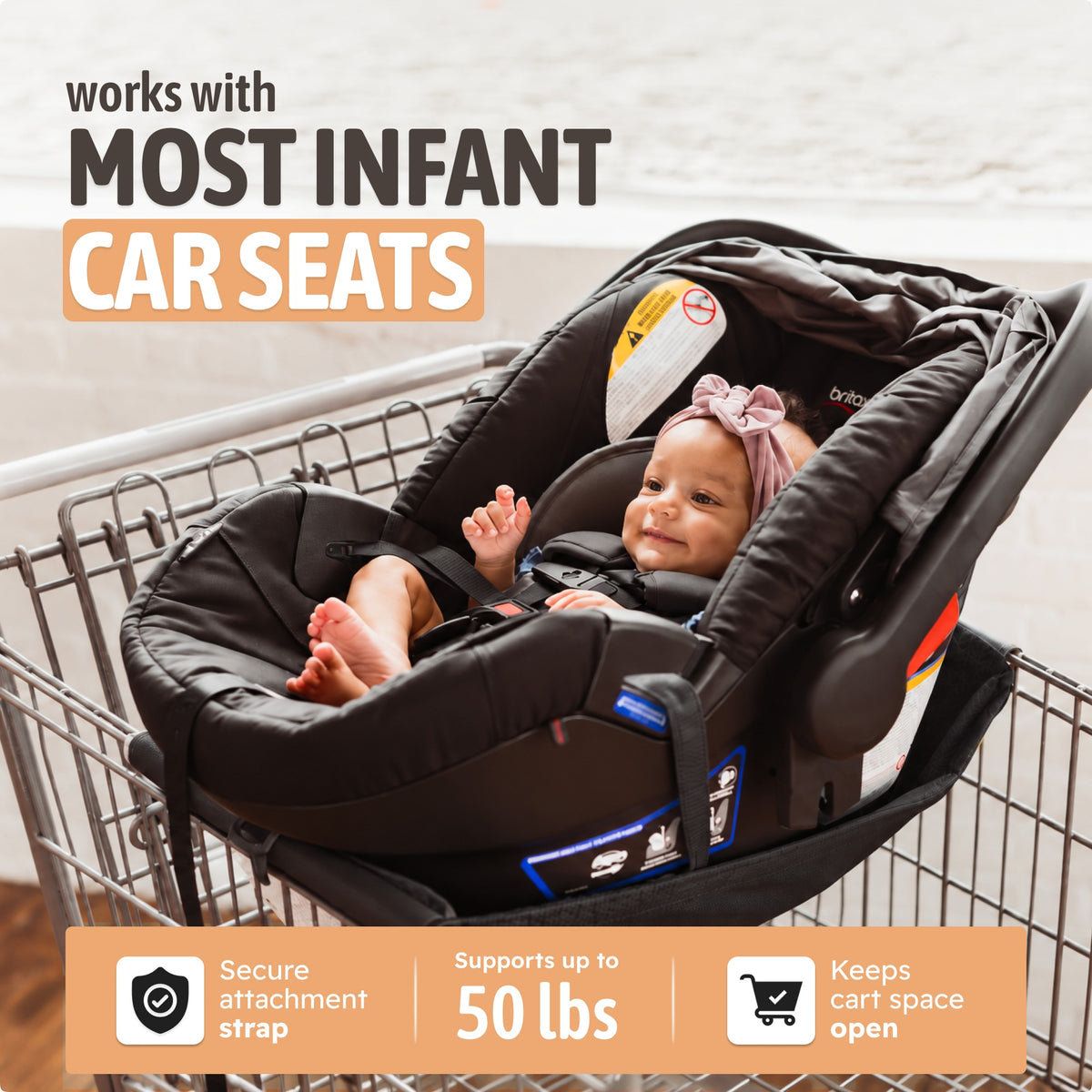Infant car seat secured in the black Binxy Baby cart hammock with the safety strap, supports up to 50 lbs and keeps cart space open